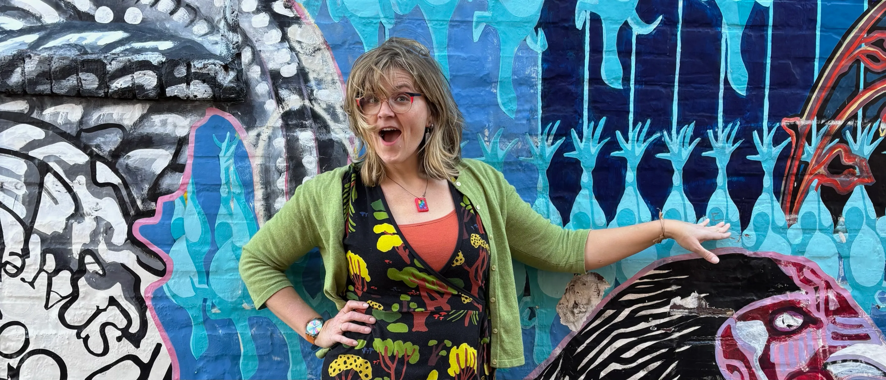 Headshot of Teresa Fisher, PhD. in front of a mural